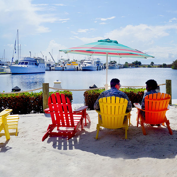 People sitting waterfront by a marina