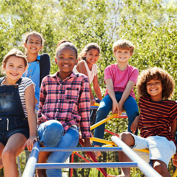 6 kids sitting on playground equipment